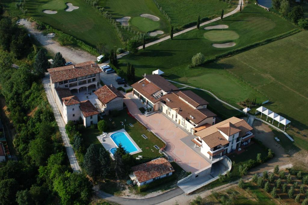 an aerial view of a house with a golf course at Il Colombaro in Salò