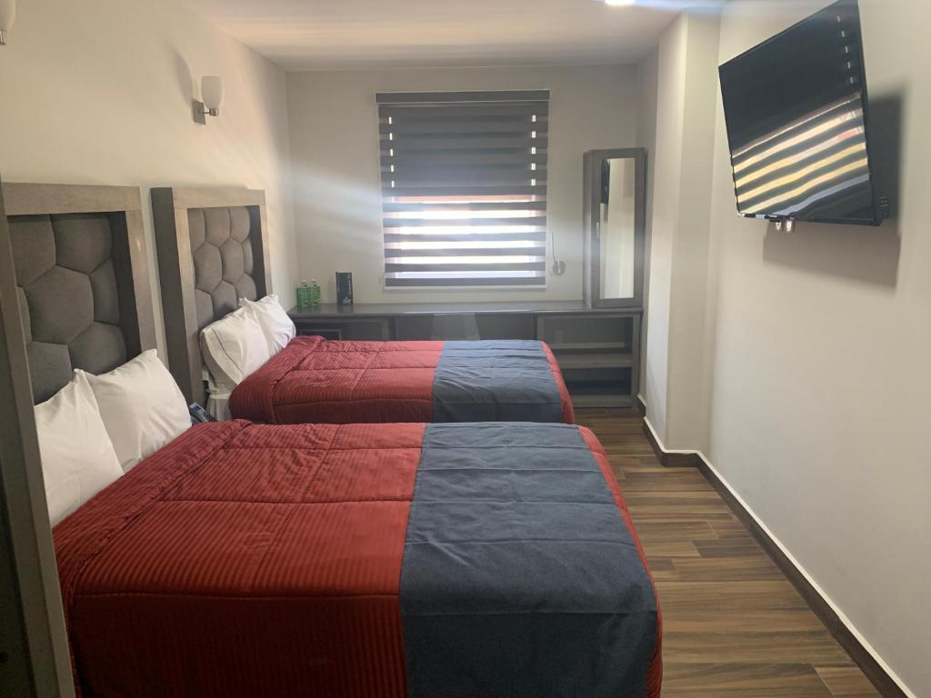 Postel nebo postele na pokoji v ubytování Hotel ANB Aeropuerto Guadalajara