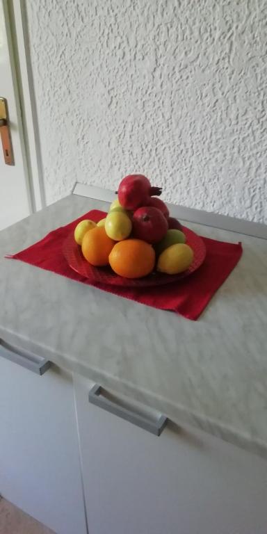 a plate of fruit on a red napkin on a table at Apartment M&amp;A in Osijek