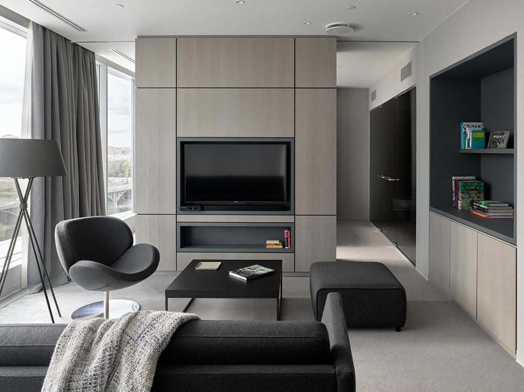 a living room with a couch and a tv at Hotel Residence in Yekaterinburg