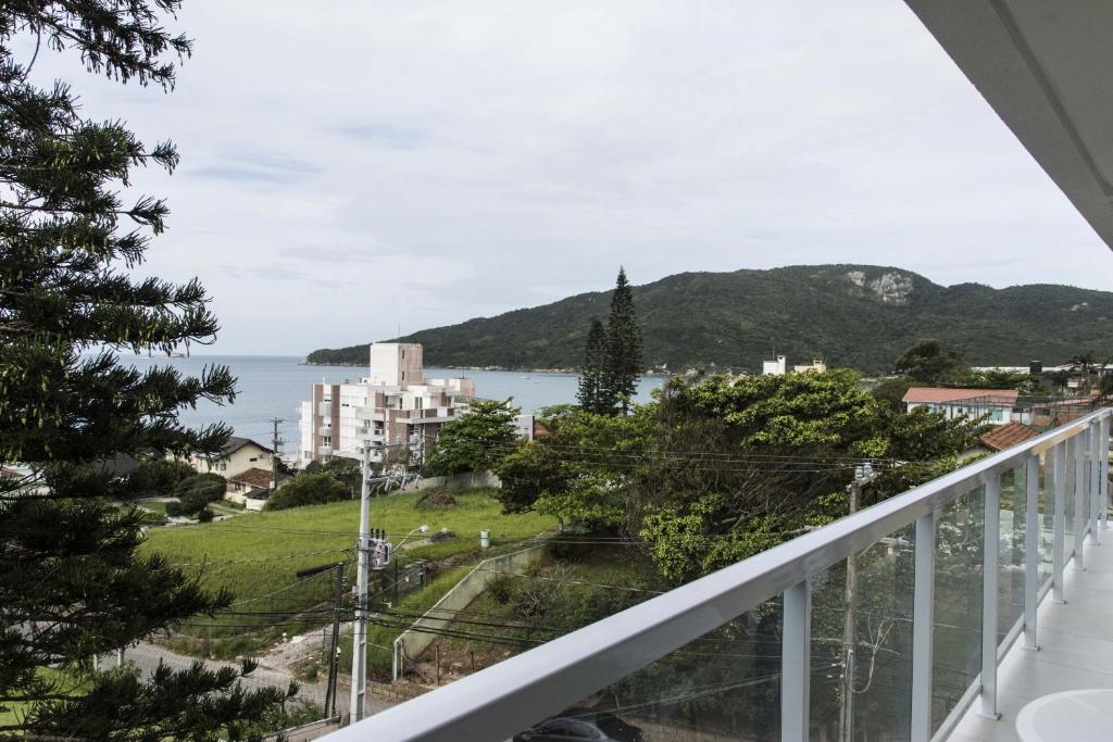 a balcony with a view of the ocean and a city at Luxo Vista Mar a 50 m da Praia nos Ingleses ING9302 in Florianópolis