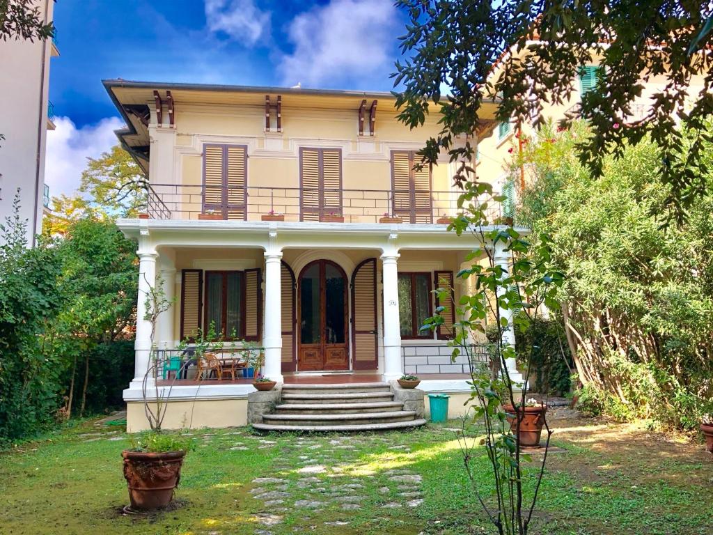 a large white house with a porch and stairs at Villa Puccini in Montecatini Terme