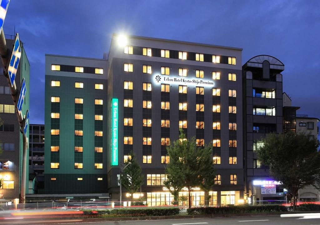 a large building with lights on it at night at Urban Hotel Kyoto Shijo Premium in Kyoto