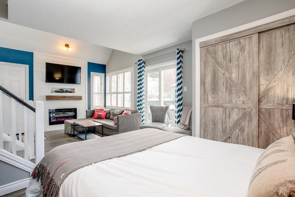 a bedroom with a large bed with a sliding barn door at Blue Mountain Studio Loft at North Creek Resort in Blue Mountains
