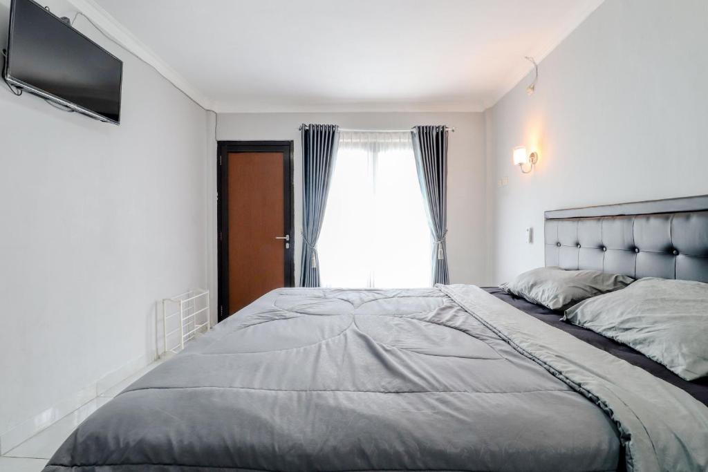 Postel nebo postele na pokoji v ubytování E Kamar Jogja
