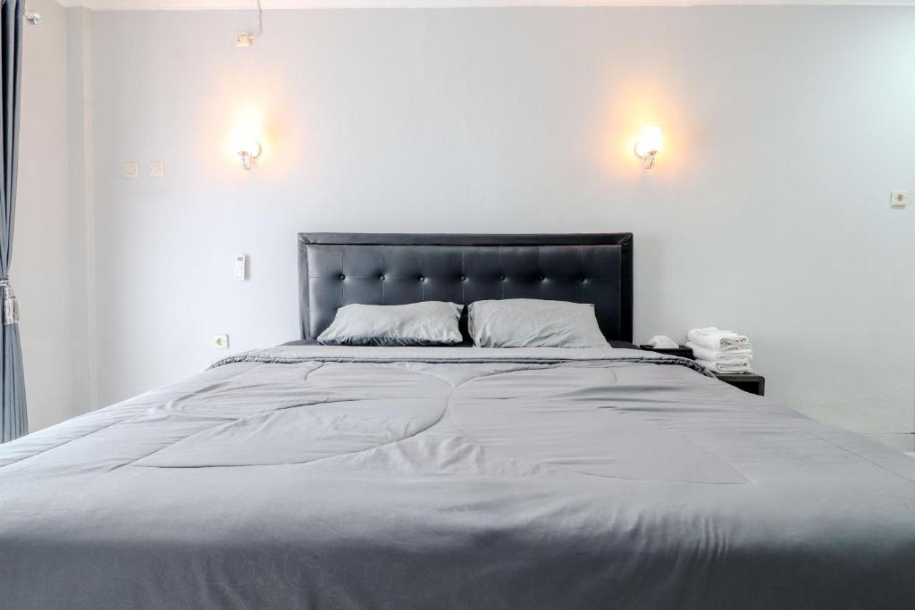 Postel nebo postele na pokoji v ubytování E Kamar Jogja