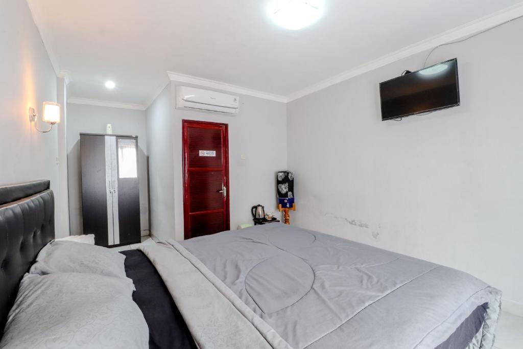Postel nebo postele na pokoji v ubytování E Kamar Jogja