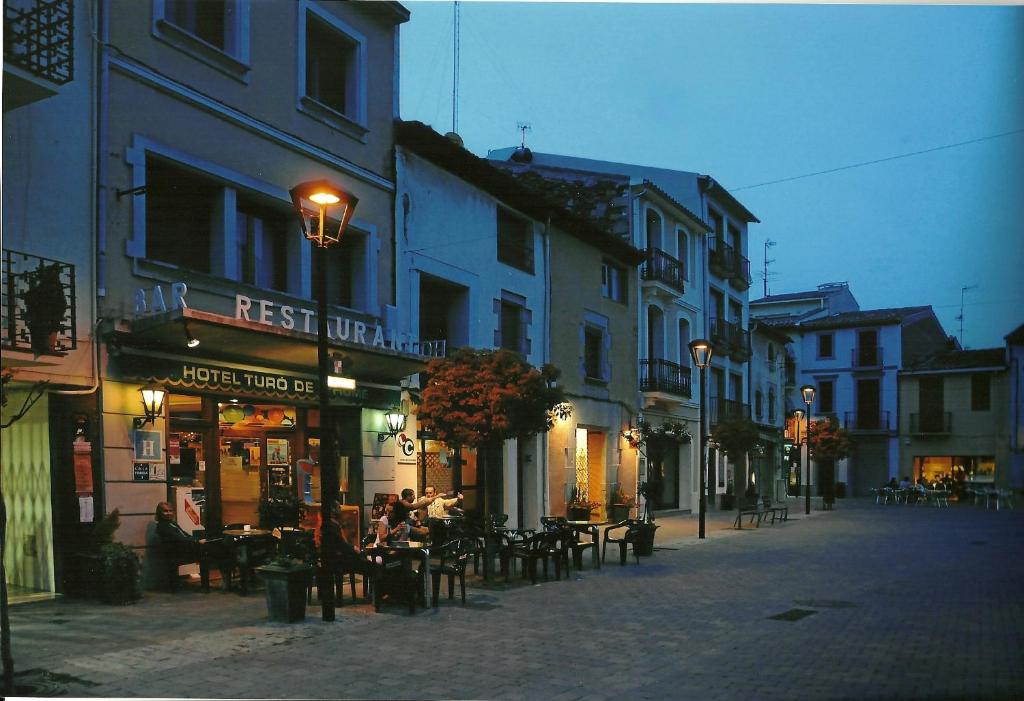 a city street with tables and chairs and buildings at Turó de L´Home in Santa María de Palautordera