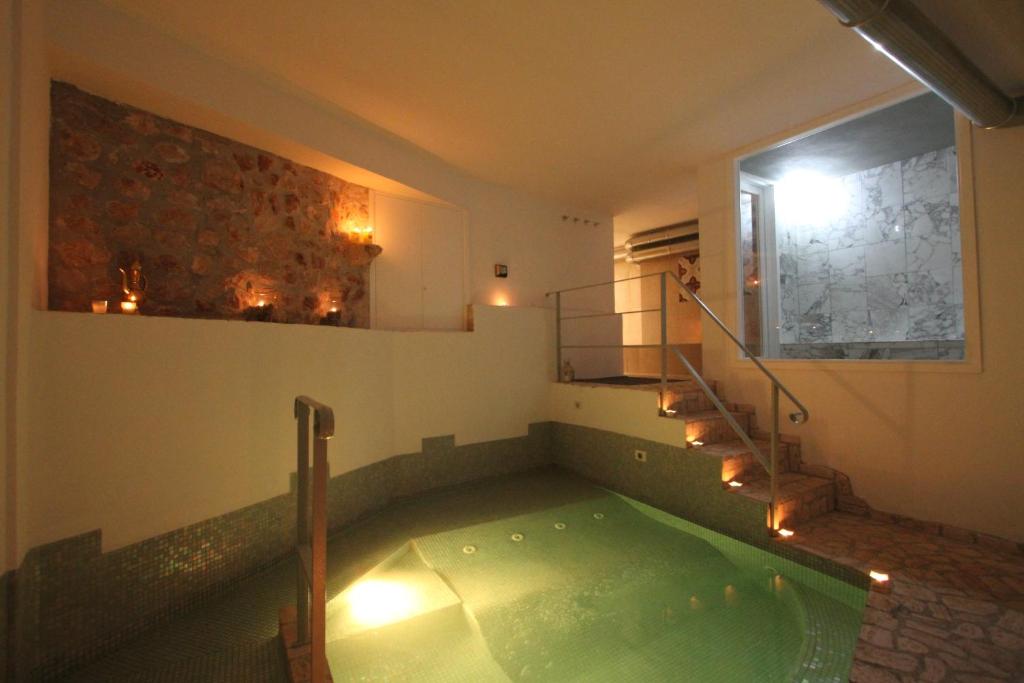 a jacuzzi tub in a room with a staircase at Le Camere Pinte in Sermoneta