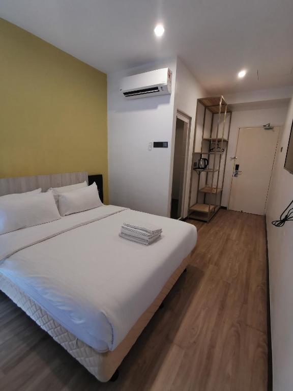 Postel nebo postele na pokoji v ubytování TT Dorf Hotel Matang