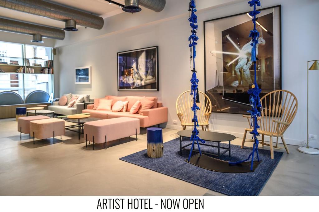 
a living room filled with furniture and a large window at Artist Hotel - an Atlas Boutique Hotel in Tel Aviv
