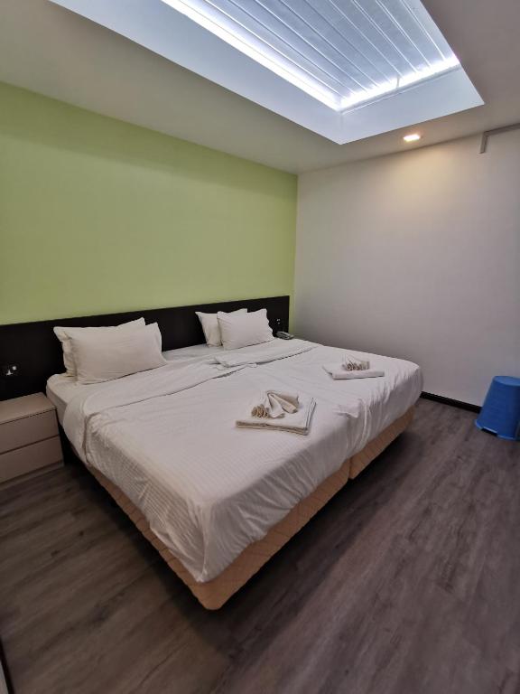 Postel nebo postele na pokoji v ubytování TT Dorf Hotel Matang