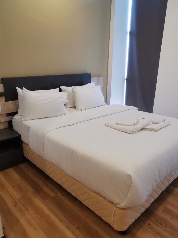 Postel nebo postele na pokoji v ubytování TT Dorf Hotel Matang