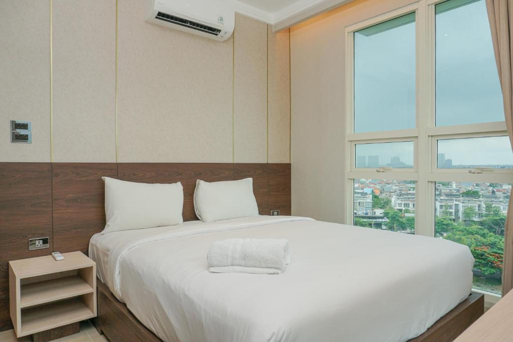 Ένα ή περισσότερα κρεβάτια σε δωμάτιο στο Elegant 2BR Citralake Suites Apartment By Travelio