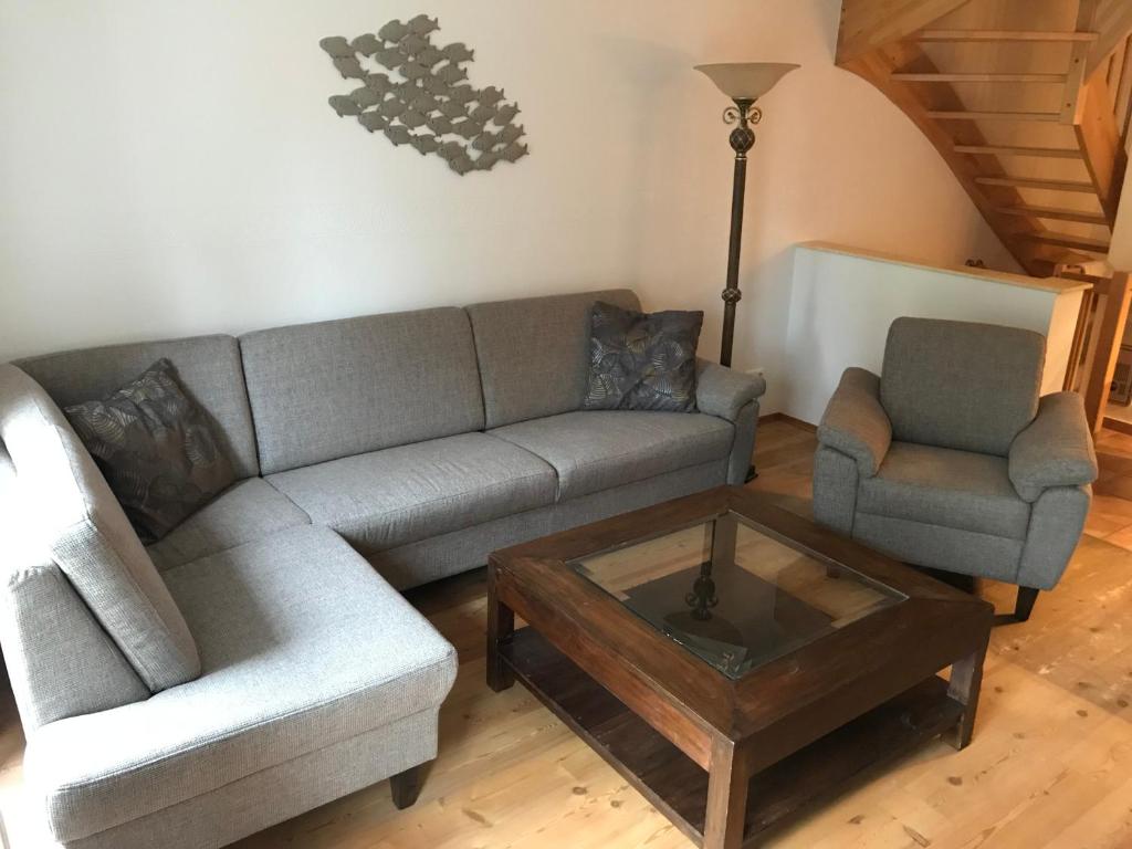 a living room with a couch and a coffee table at Ferienhaus Zander mit Sauna in Born