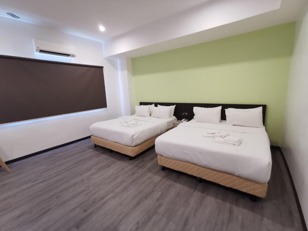 Postel nebo postele na pokoji v ubytování TT Dorf Hotel Matang