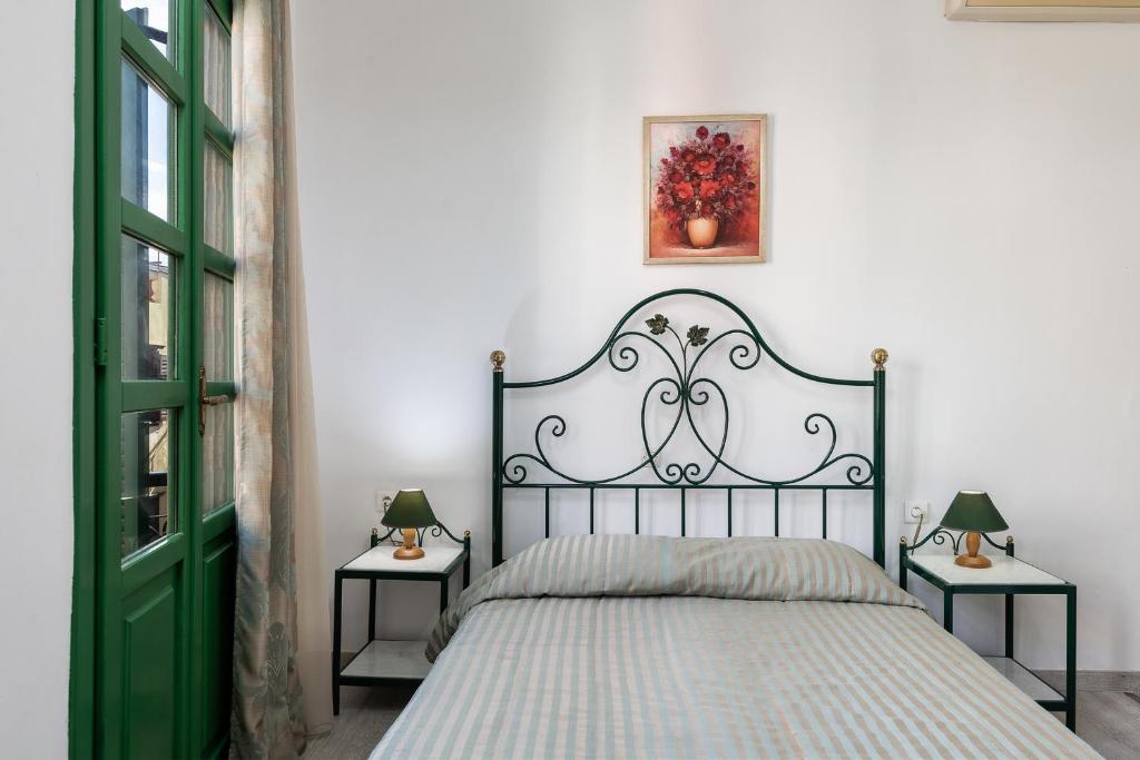 a bedroom with a black and white bed with two side tables at Anastasia Apartments in Chania