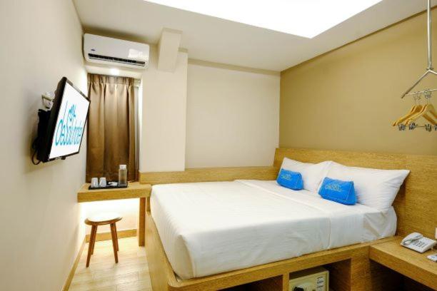Postel nebo postele na pokoji v ubytování Desatu Hotel