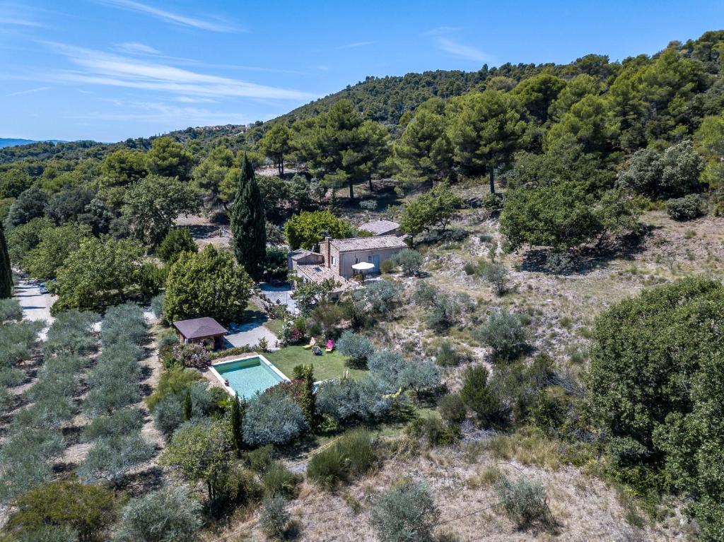 an aerial view of a home with a pool and trees at la petite maison in Vaugines