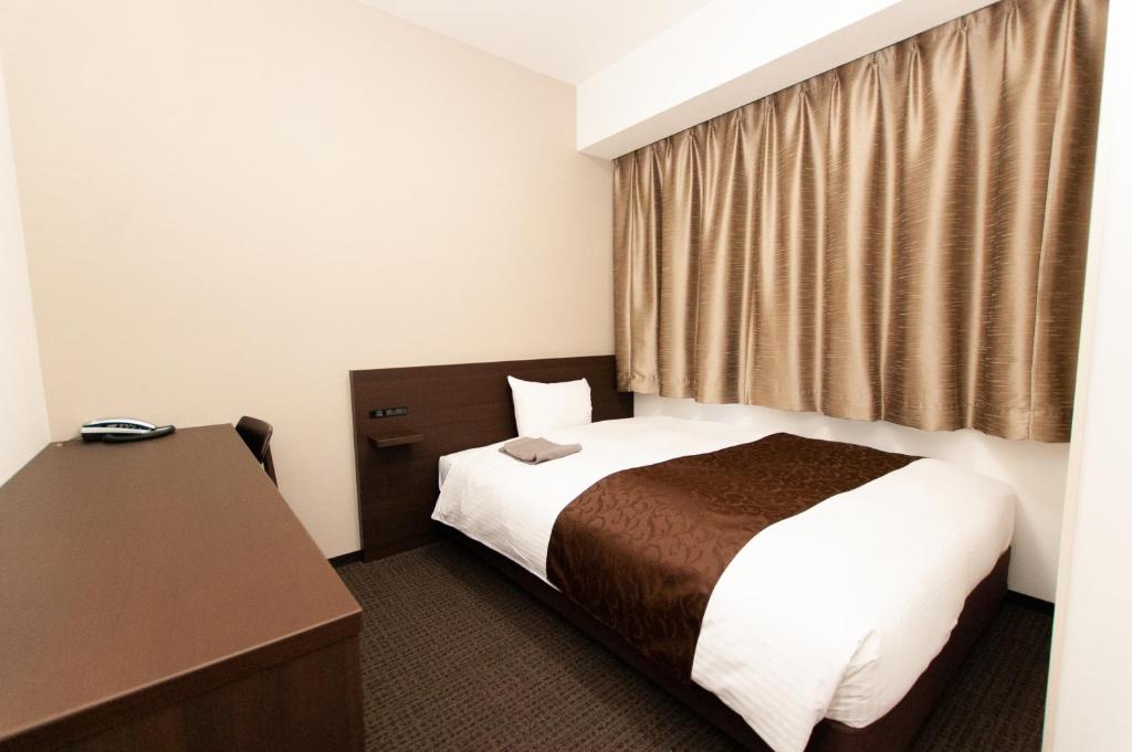 Postel nebo postele na pokoji v ubytování AI HOTEL Hashimoto