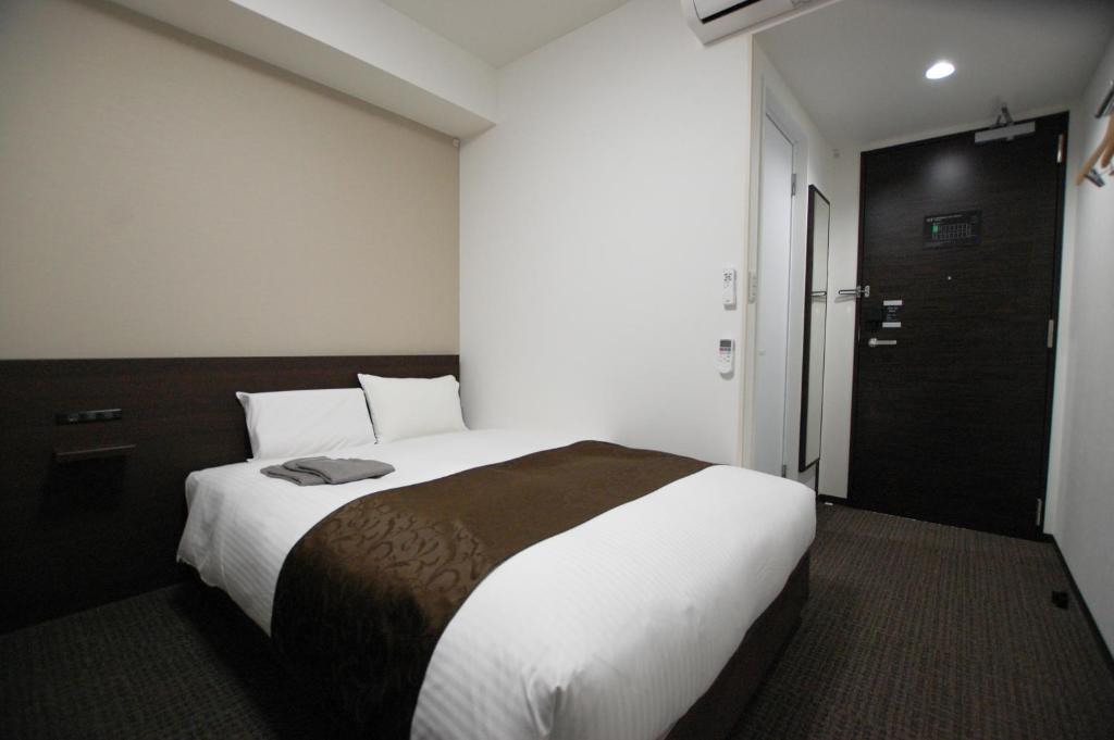 Postel nebo postele na pokoji v ubytování AI HOTEL Hashimoto