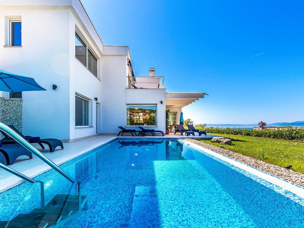 a swimming pool in front of a house at Villa Vista by Interhome in Matulji