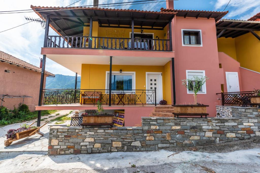 a house with a balcony and a porch at Demmy's Apartment in Potamiá
