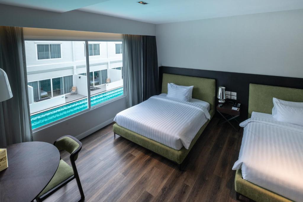 Postel nebo postele na pokoji v ubytování S Ram Leisure Hotel SHA PLUS
