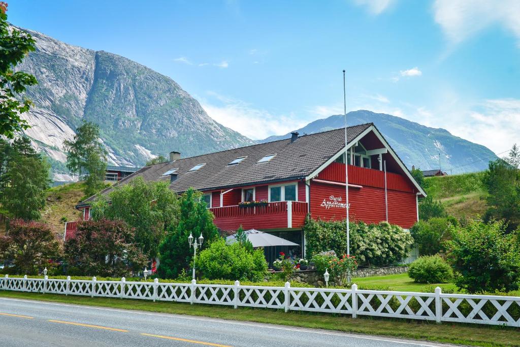 a red house on the side of a mountain at Ingrids Apartments in Eidfjord