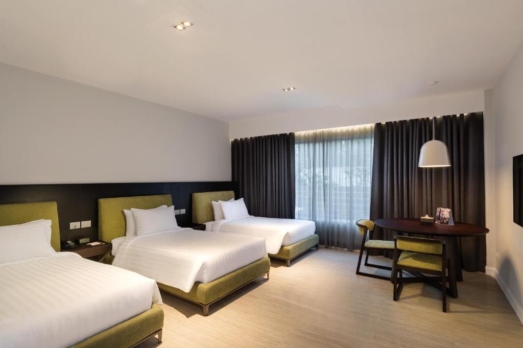 Postel nebo postele na pokoji v ubytování S Ram Leisure Hotel SHA PLUS