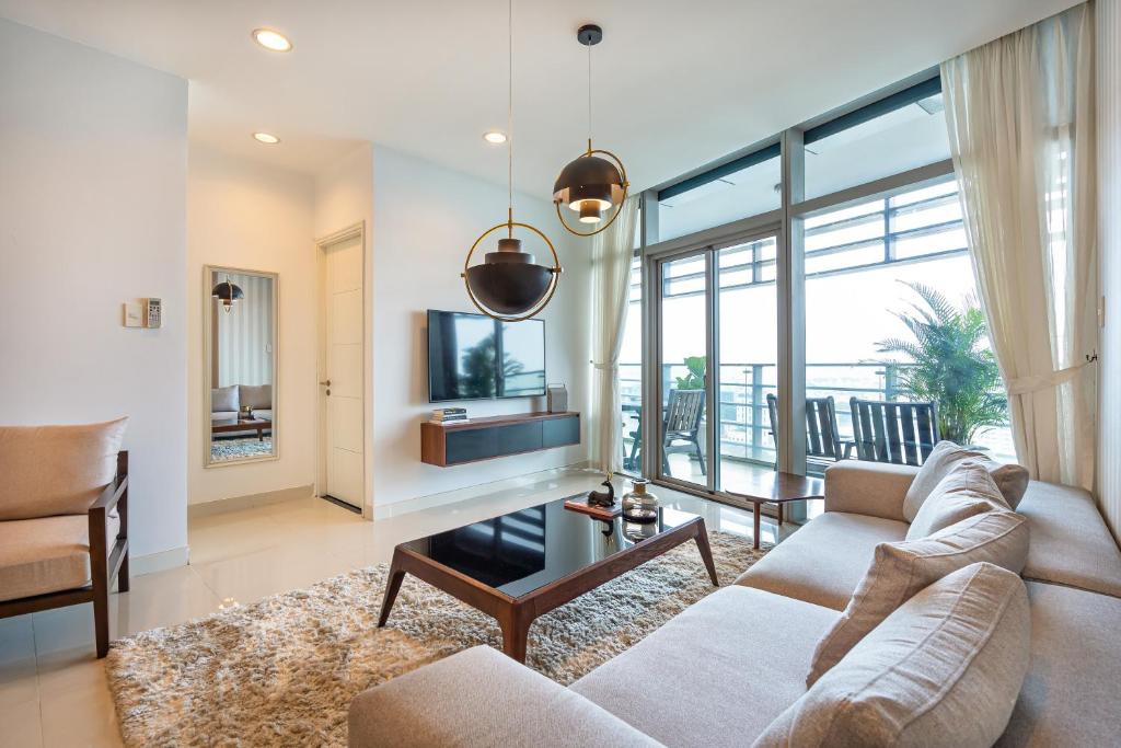 a living room with a couch and a table at Spacious Central Apartments for Group and Family - Sailing Tower in Ho Chi Minh City