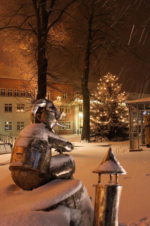 a statue of a squirrel in the snow at night at Spree Chalet - adults only in Lübbenau