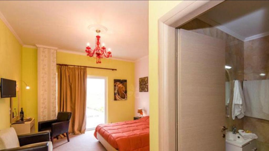 a bedroom with a bed and a bathroom at Paradice Hotel Luxury Suites-Near zorbas Beach-FREE Breakfast in Stavros