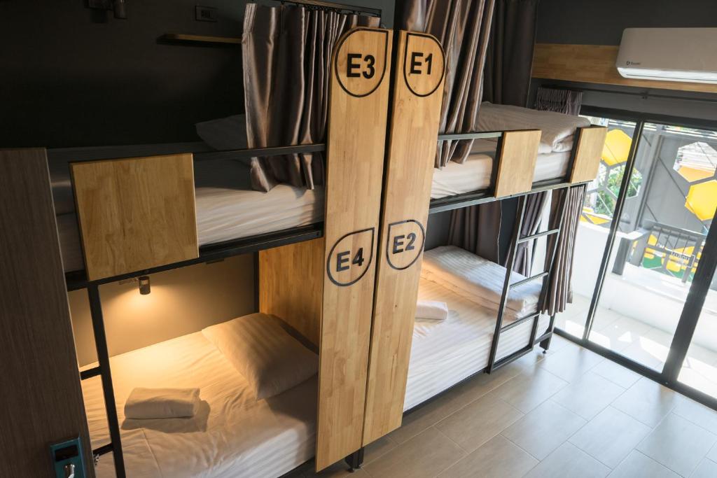 a group of bunk beds in a room at Ray Hostel in Chiang Mai