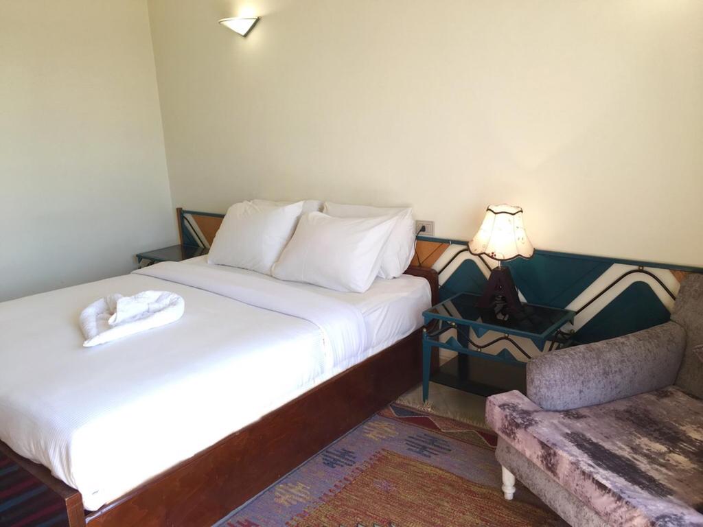 Postel nebo postele na pokoji v ubytování New Memnon Hotel