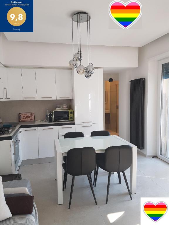 a kitchen with a table and chairs in a room at Seventy in Sperlonga