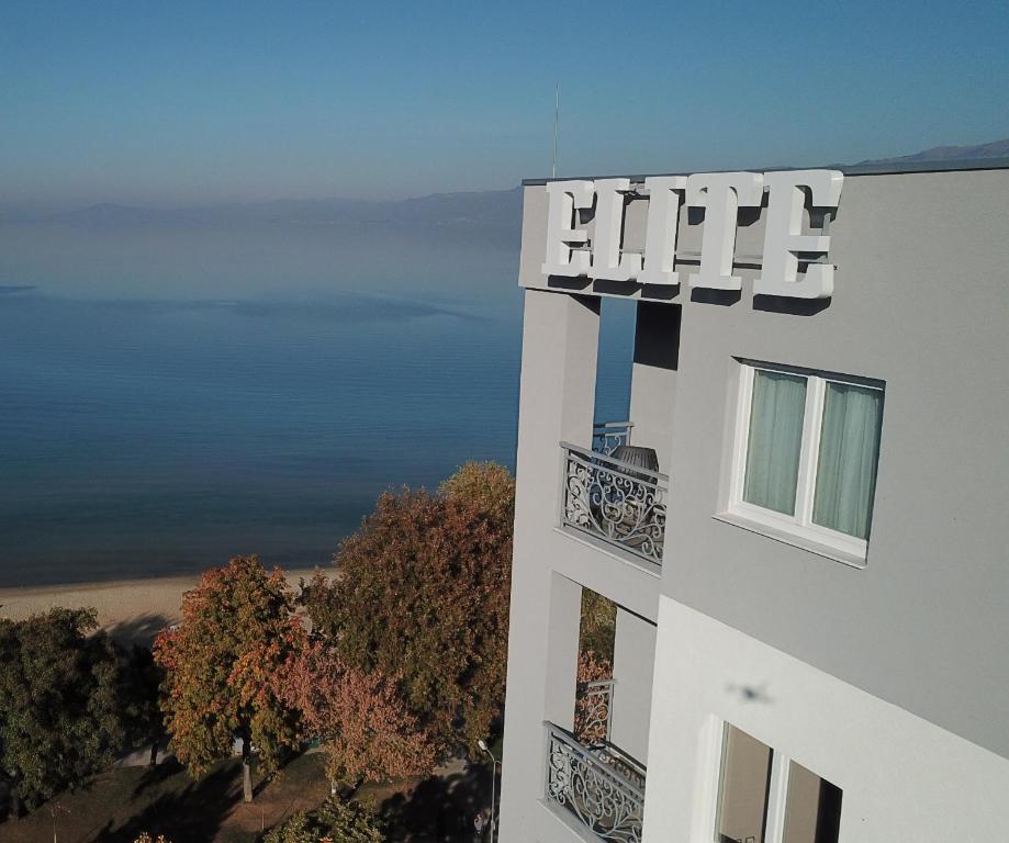a white building with a sign on the side of it at Elite in Pogradec
