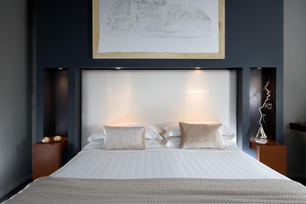 Postel nebo postele na pokoji v ubytování Metropolis - Hotel di Charme