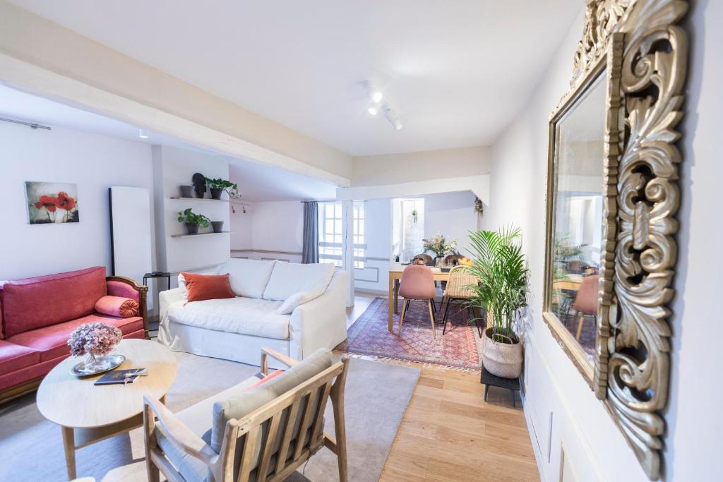 a living room with a couch and a table at Sweet Home Rennes Centre Historique 65 m2 in Rennes