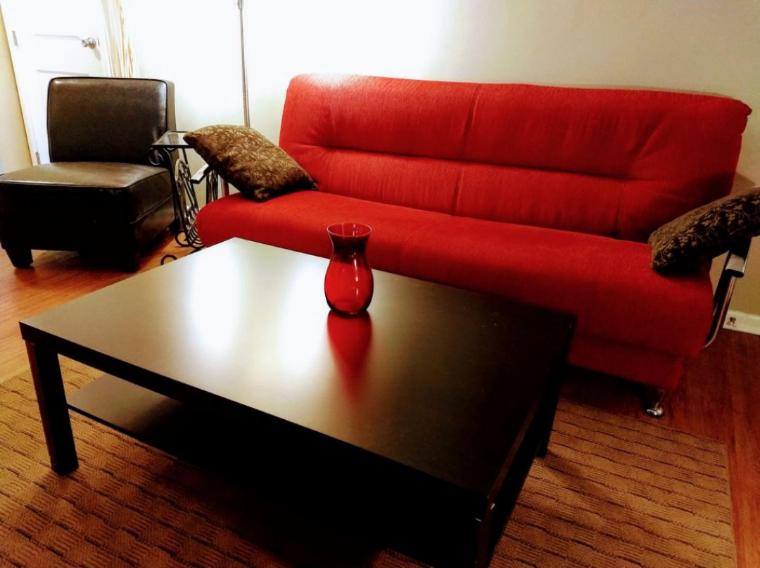 a red couch and a coffee table in a living room at Short North/OSU Pet Friendly! in Columbus