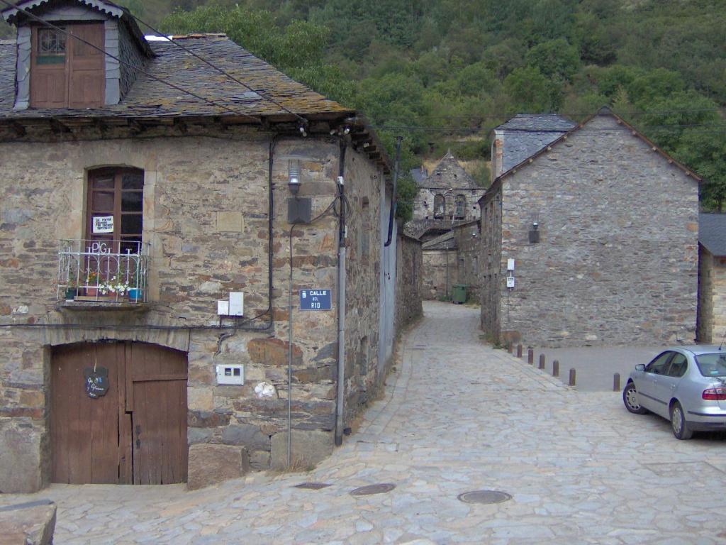 Colinas del Campo de Martín Moro的住宿－Casa Trallera，老石头建筑中一条小巷,有车