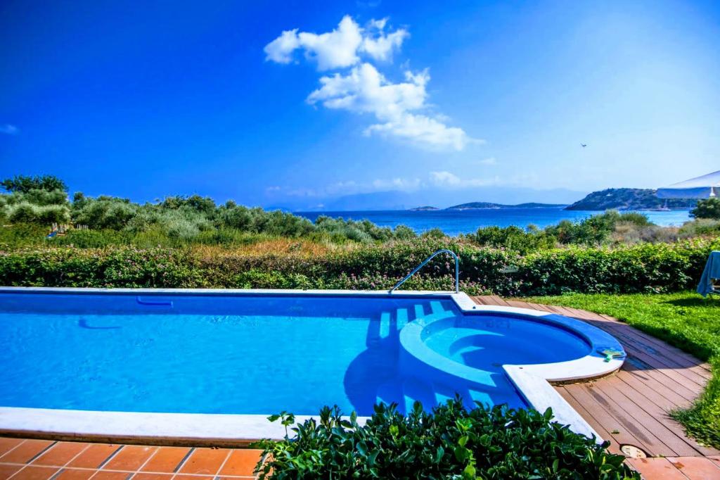 a swimming pool with a view of the ocean at Mirabella Apartments in Agios Nikolaos