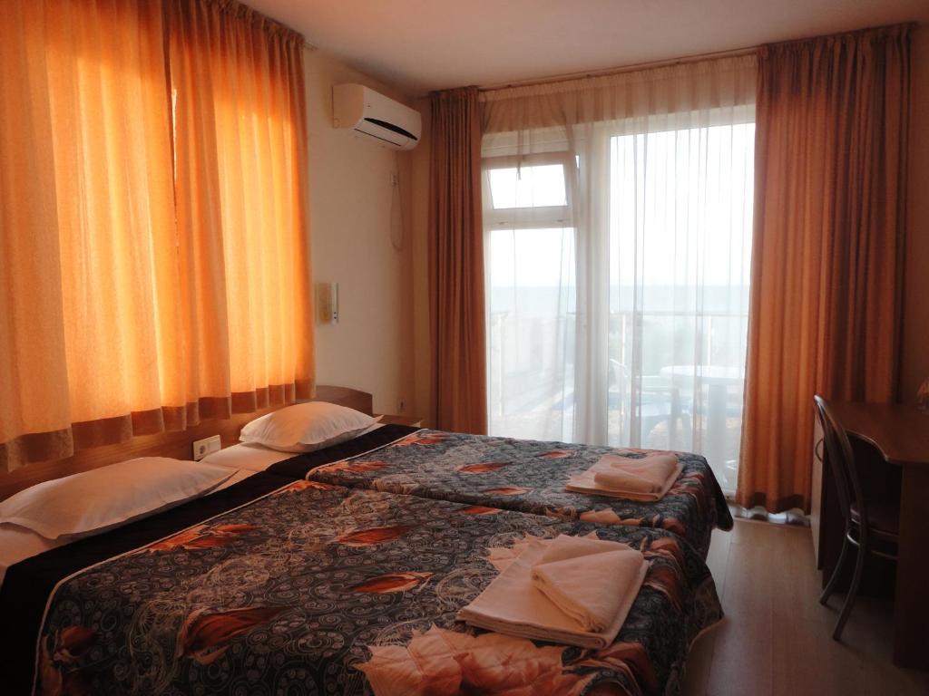Postel nebo postele na pokoji v ubytování Barex Family Hotel
