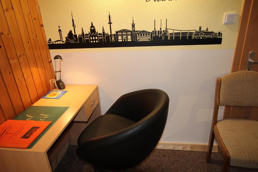 a office with a desk and a chair next to a desk at ABT - Private Room for 1 in Hannover