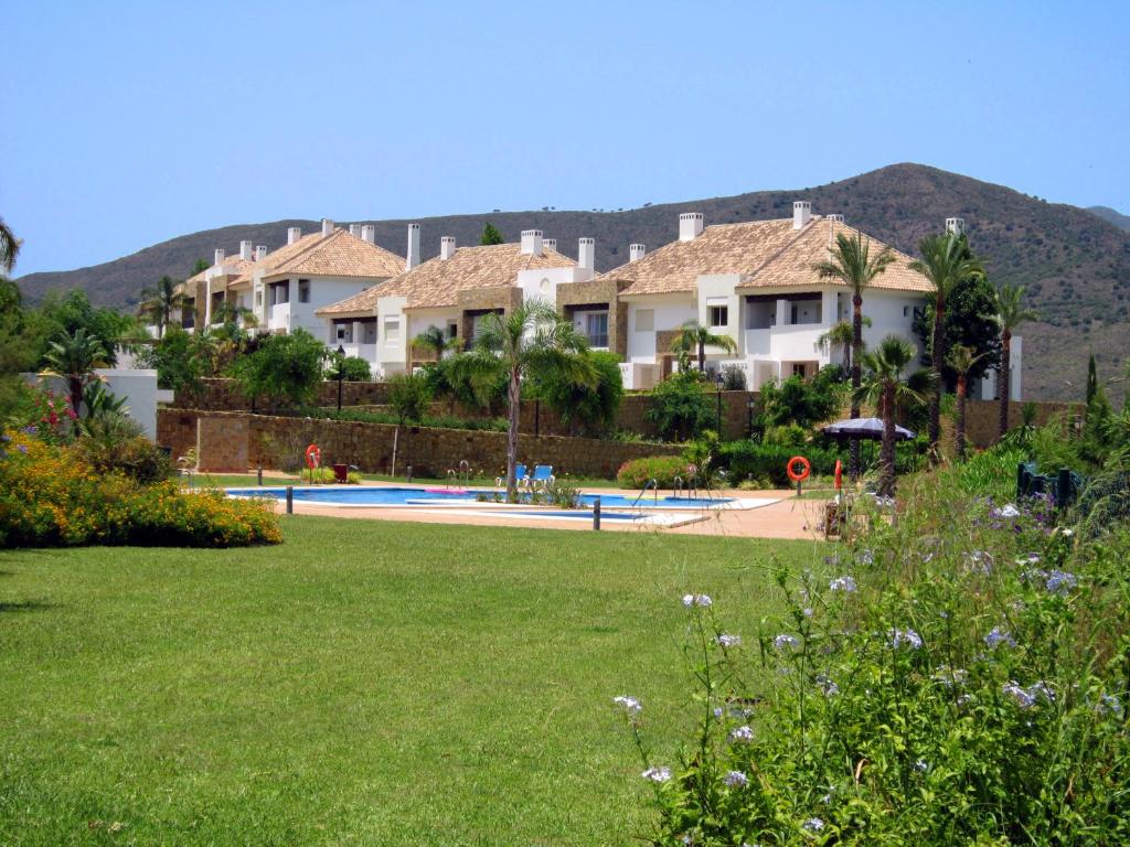 a view of a yard with houses and a pool at La Cala Golf Luxury TownHouse, frontline golf, spectacular views in La Cala de Mijas
