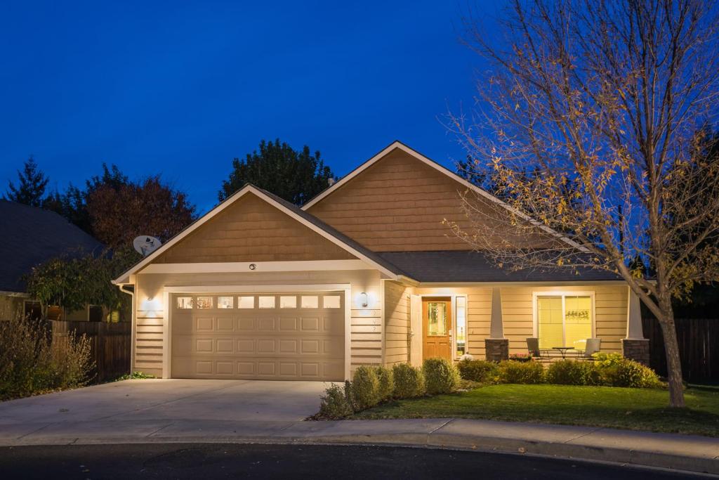 a house with a garage at night at Charming Wine Country Retreat! 4 Bedroom 2 Bath in Walla Walla