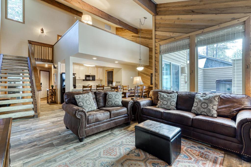 a living room with leather couches and a staircase at 2 Conifer in Sunriver