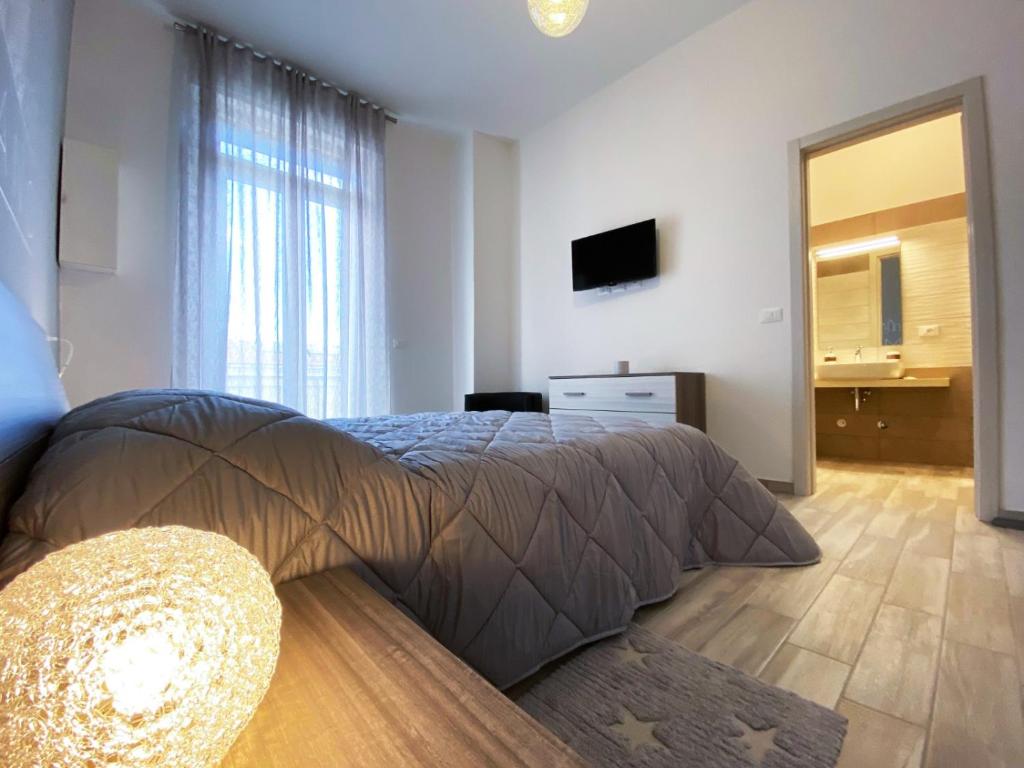a bedroom with a large bed and a television at Doni B&B in Lanciano