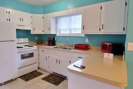 a kitchen with white cabinets and a counter top at LAKE GEORGE FAMILY VACATION HOME in Lake George
