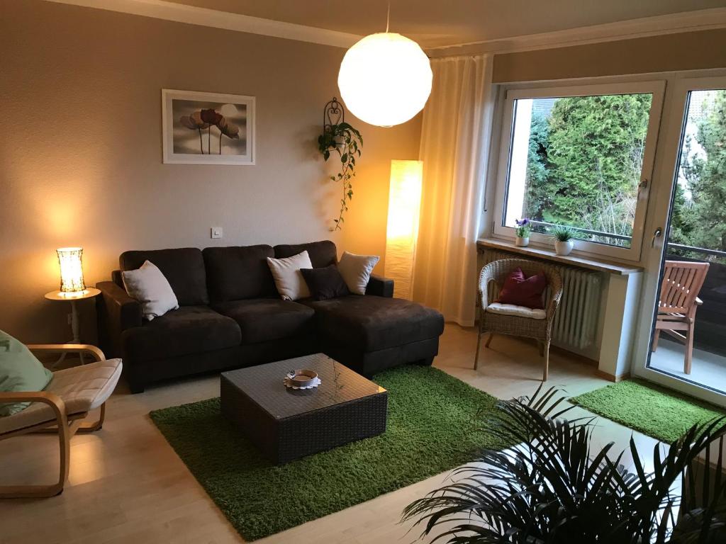 a living room with a couch and a table at Gästehaus Ertel - Ferienwohnung in Erding in Erding